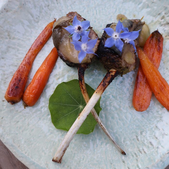 Lamb chops plated with carrots