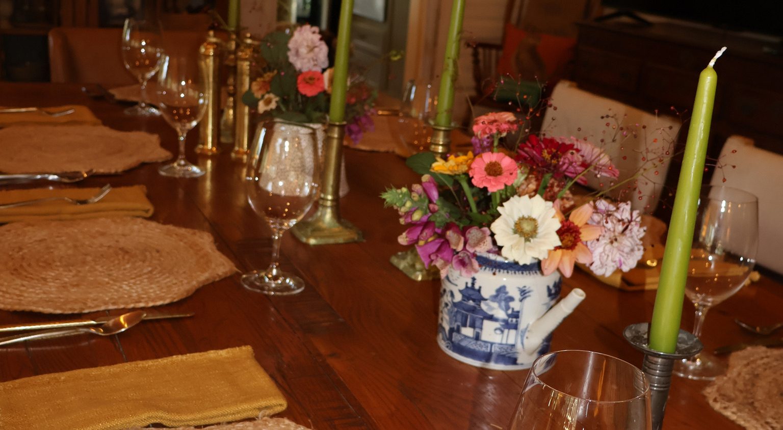 A table set with a lit candle and flowers