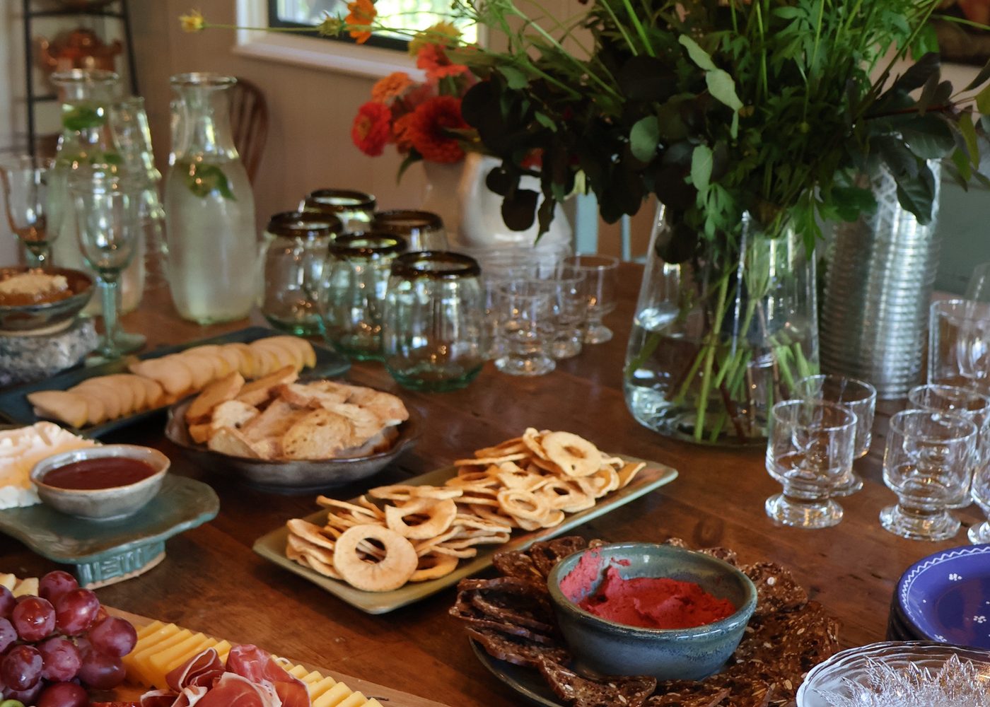 A table laid with flowers, plates and glasses