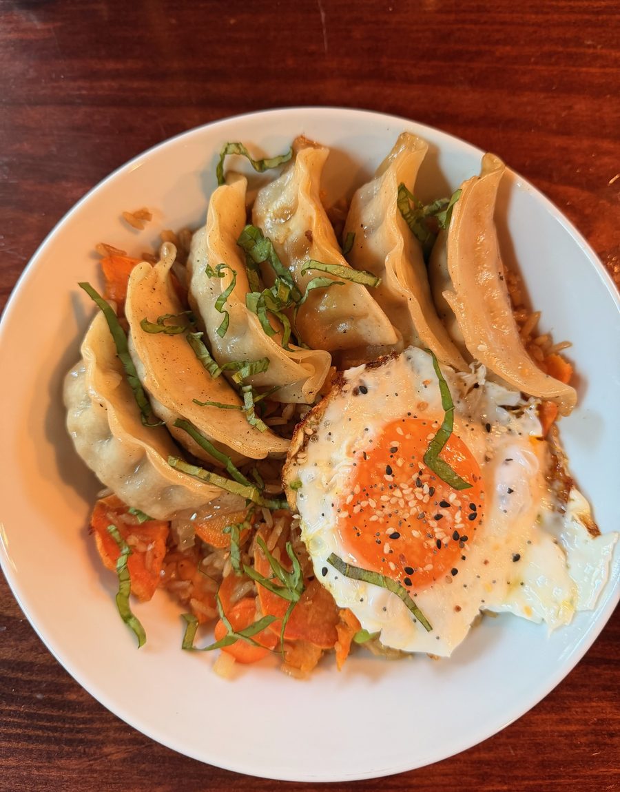 Pan-fried dumplings with a fried egg