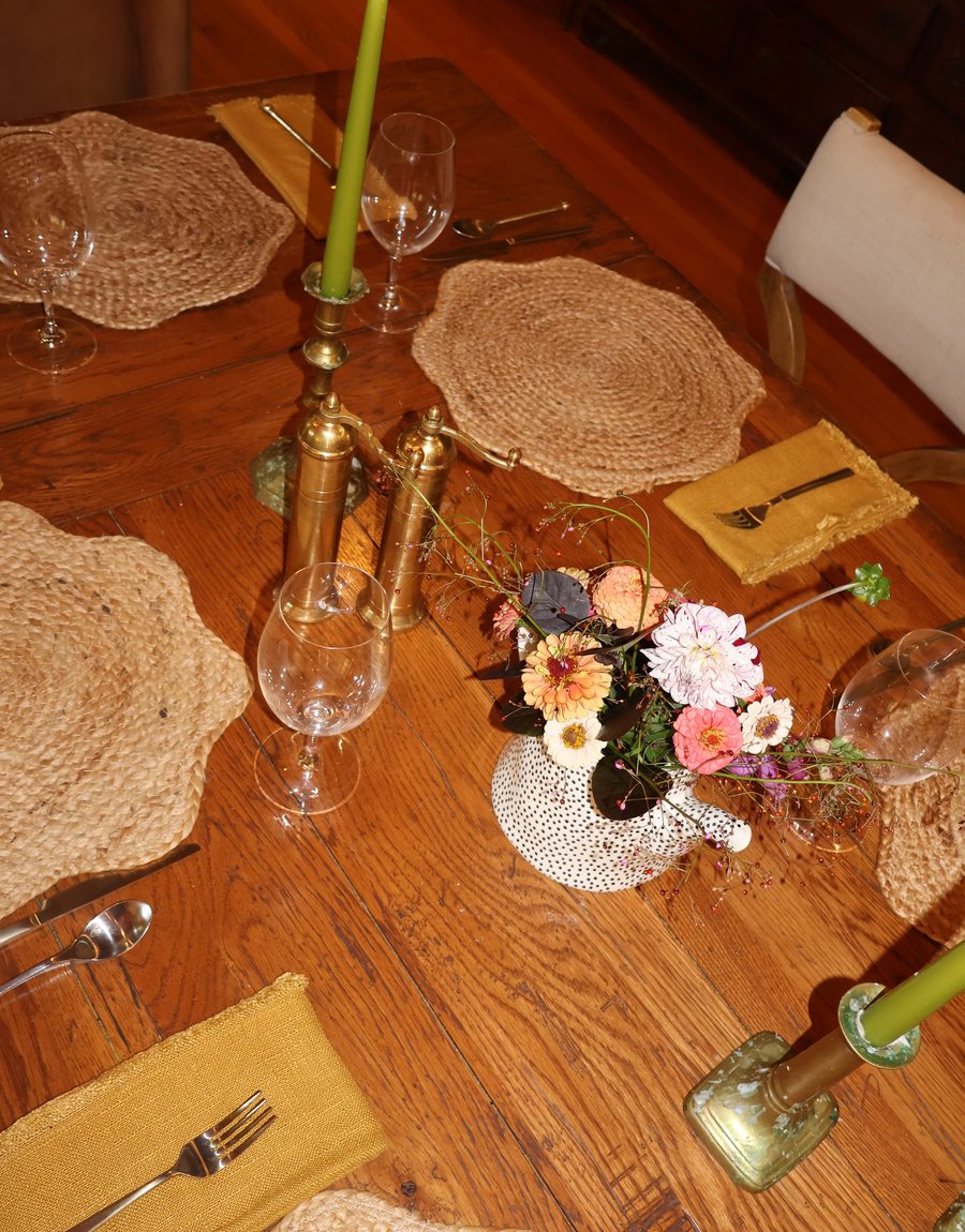 Woven mats, candles and flowers down the table